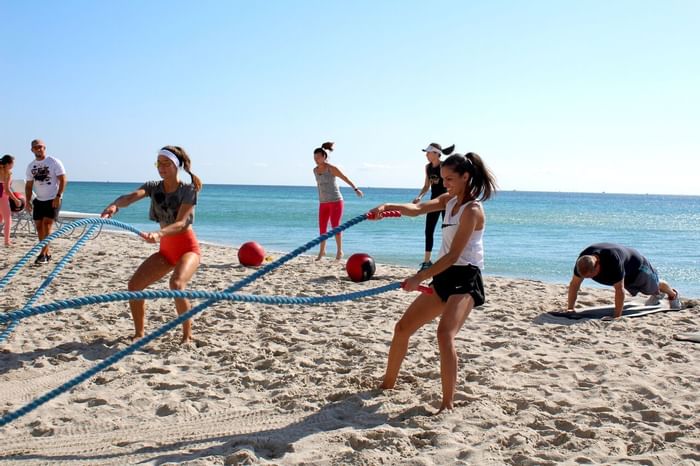 People doing fitness exercises near the beach at Diplomat