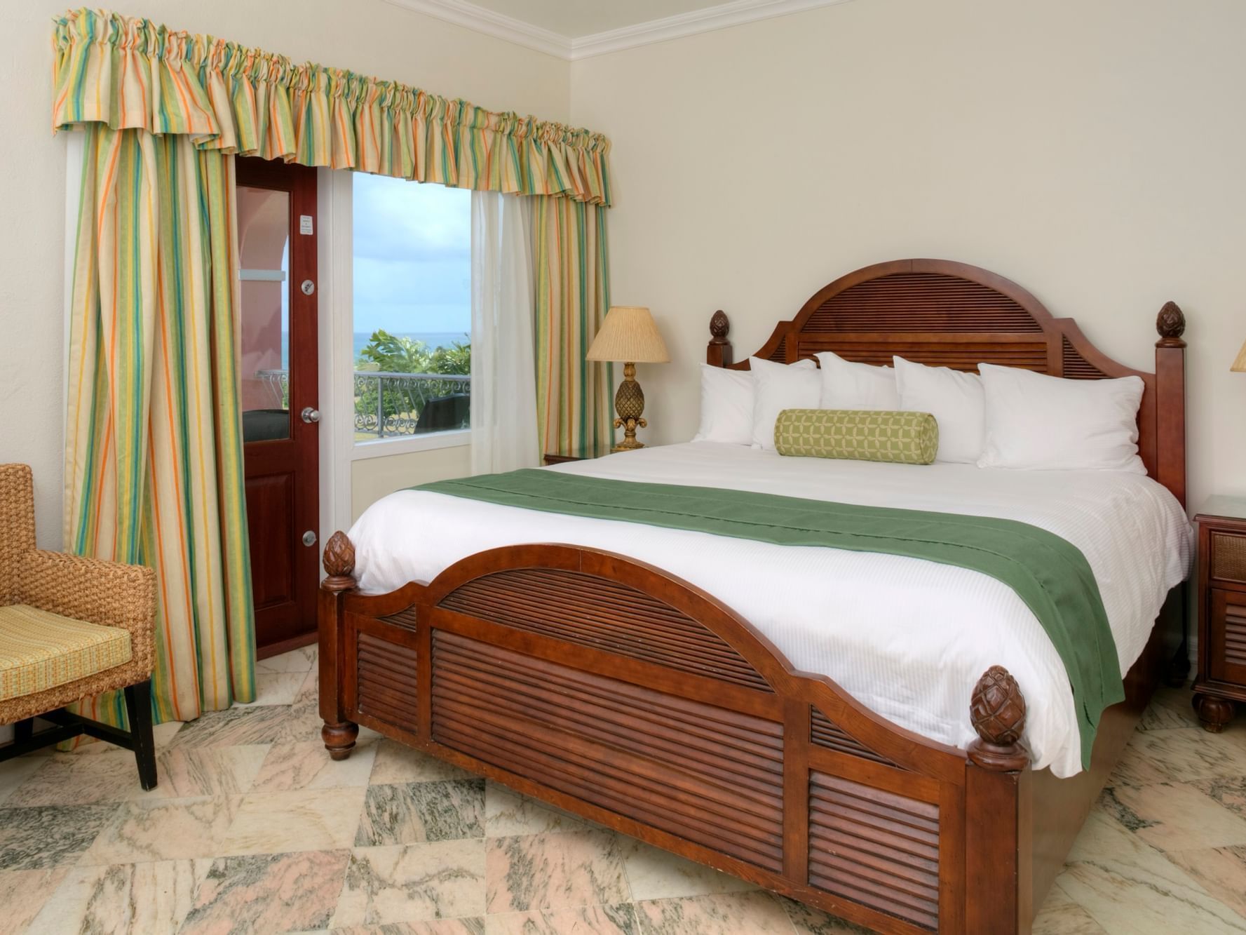 Cozy bed in Great House Ocean View Room at Buccaneer Hotel