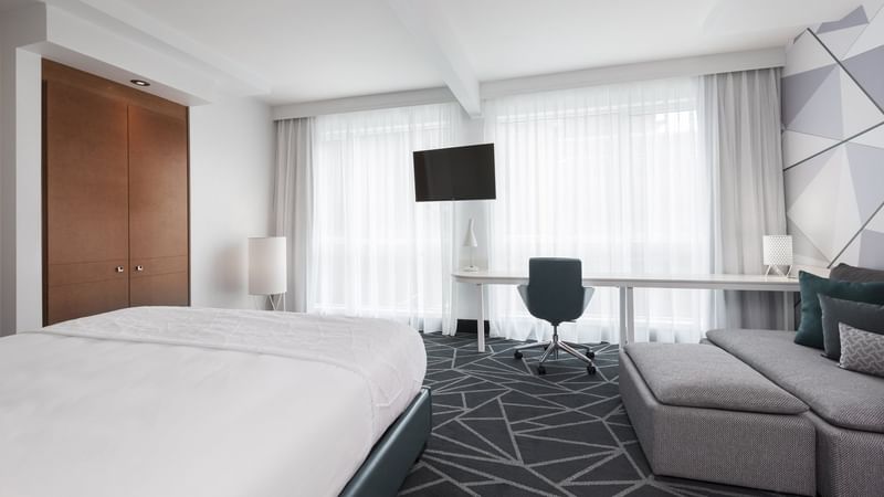 Spacious Loft Suite with TV, bed and work area at Warwick Le Crystal