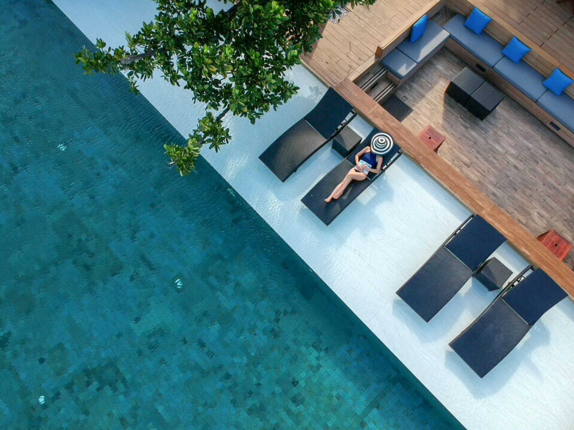 Aerial view of lady on a sunbed at U Hotels & Resorts