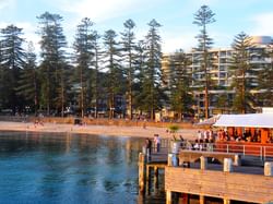 People at manly beach view of restaurant , beach and building in background