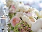 Large white and pink flower bouquet paired with green foliage and glass votive candles at The Sebel Brisbane