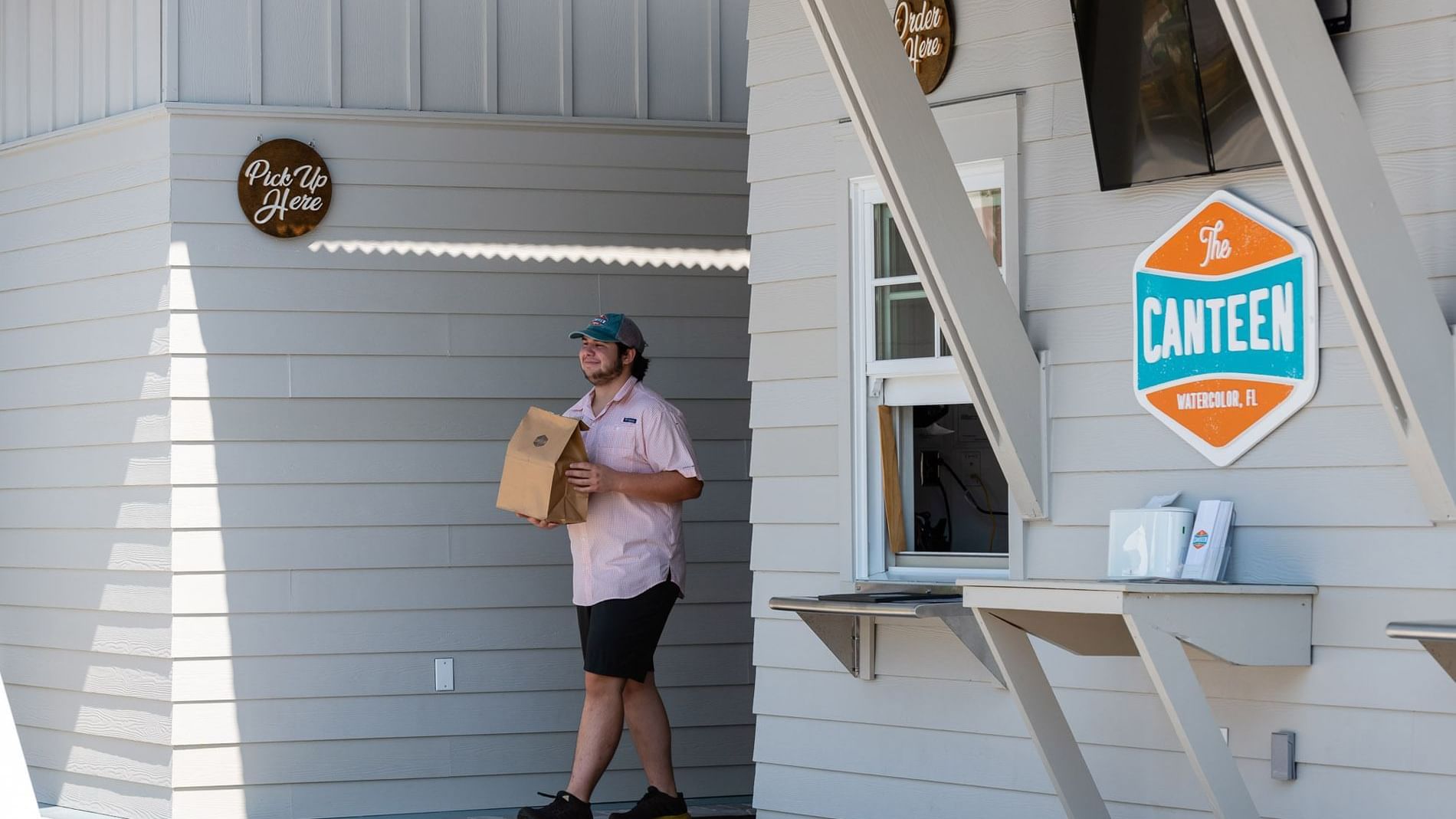 A man carrying food from the canteen at the WaterColor Inn