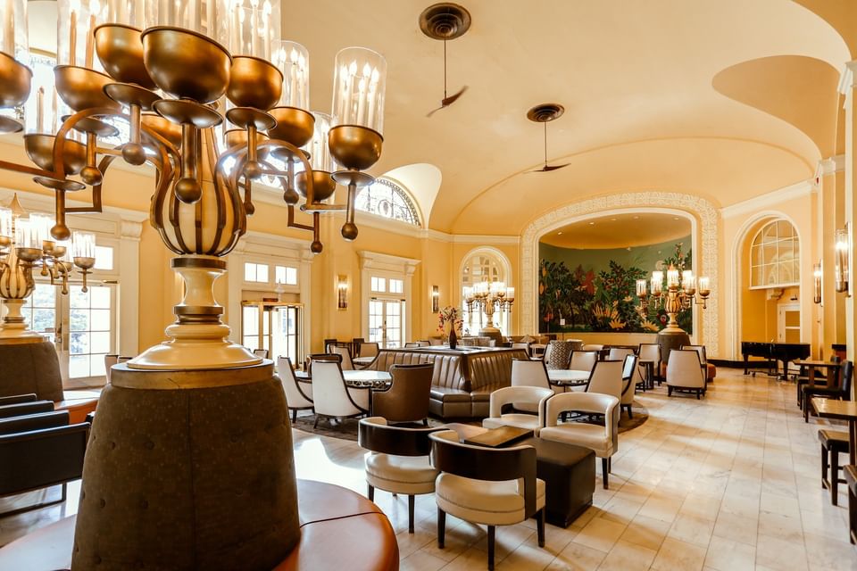 Elegant armchairs by large ornate lamps under a vaulted gold ceiling in the Arlington Resort Hotel & Spa