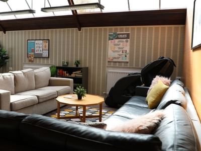 Lounge with couches, coffee table, and posters at La Trobe University - Chisholm College.