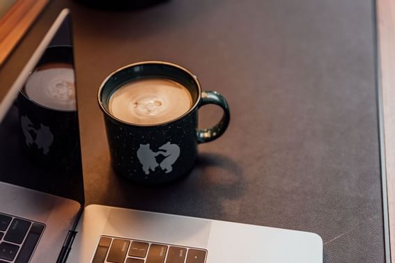 Latte coffee served on a wooden table at High Peaks Resort