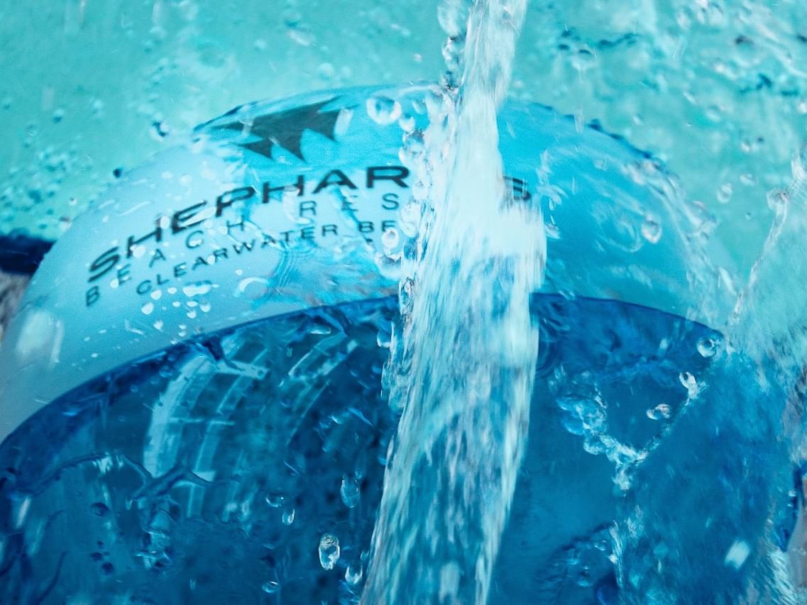 Ball with the Shephard's Beach Resort logo at the pool