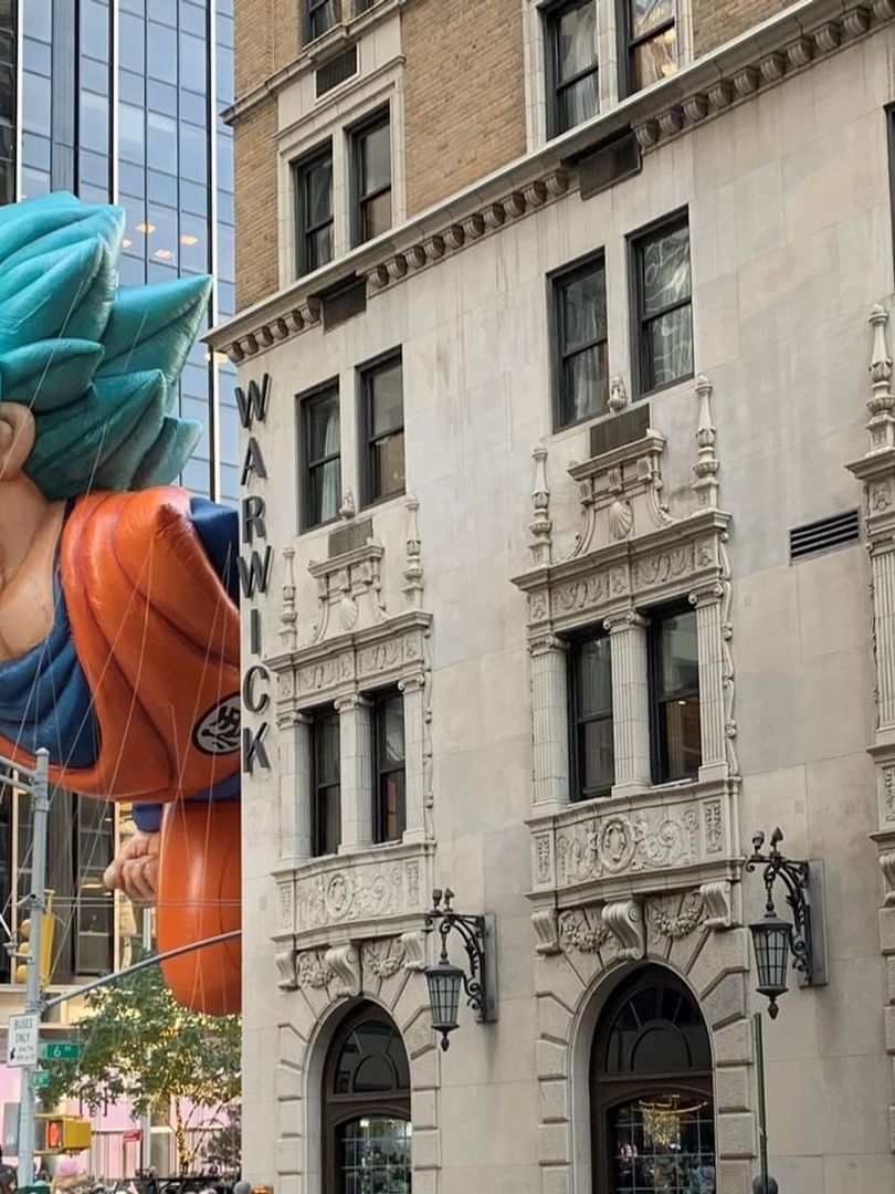 Giant Goku balloon floats past the historic Warwick Hotel during a parade in New York