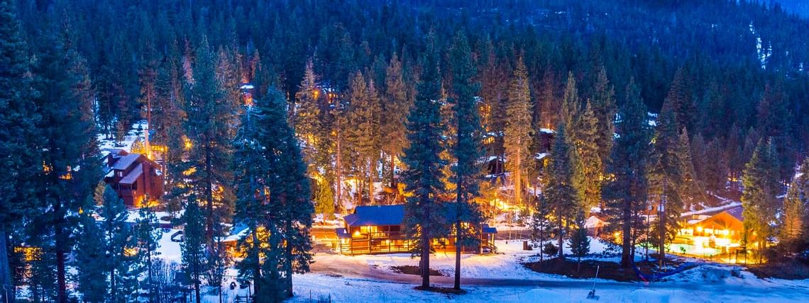 Resort exterior with snow in twilight at Granlibakken Tahoe