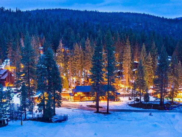 Resort exterior with snow in twilight at Granlibakken Tahoe