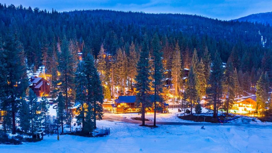 Resort exterior with snow in twilight at Granlibakken Tahoe