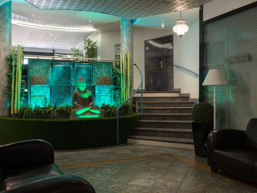 Interior of the lobby with a Buddha statue at Hotel Alteora