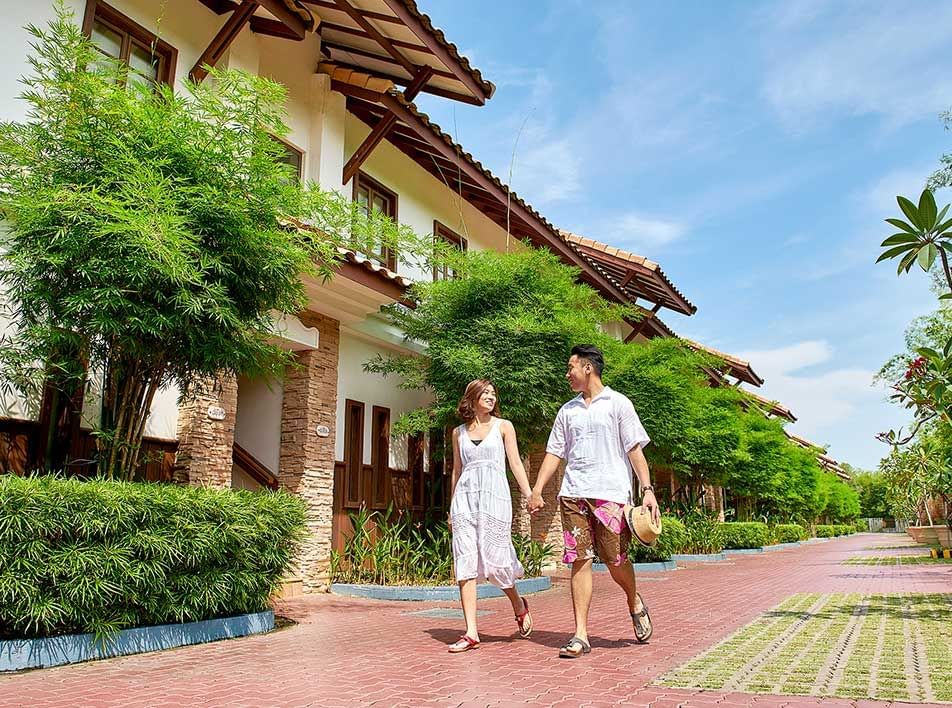 A happy couple walk hand in hand around the resort - Grand Lexis Port Dickson