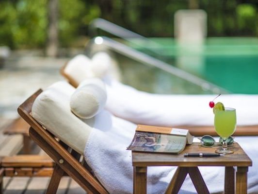 Cocktail served by a sunbed near the outdoor pool at The Explorean Resorts