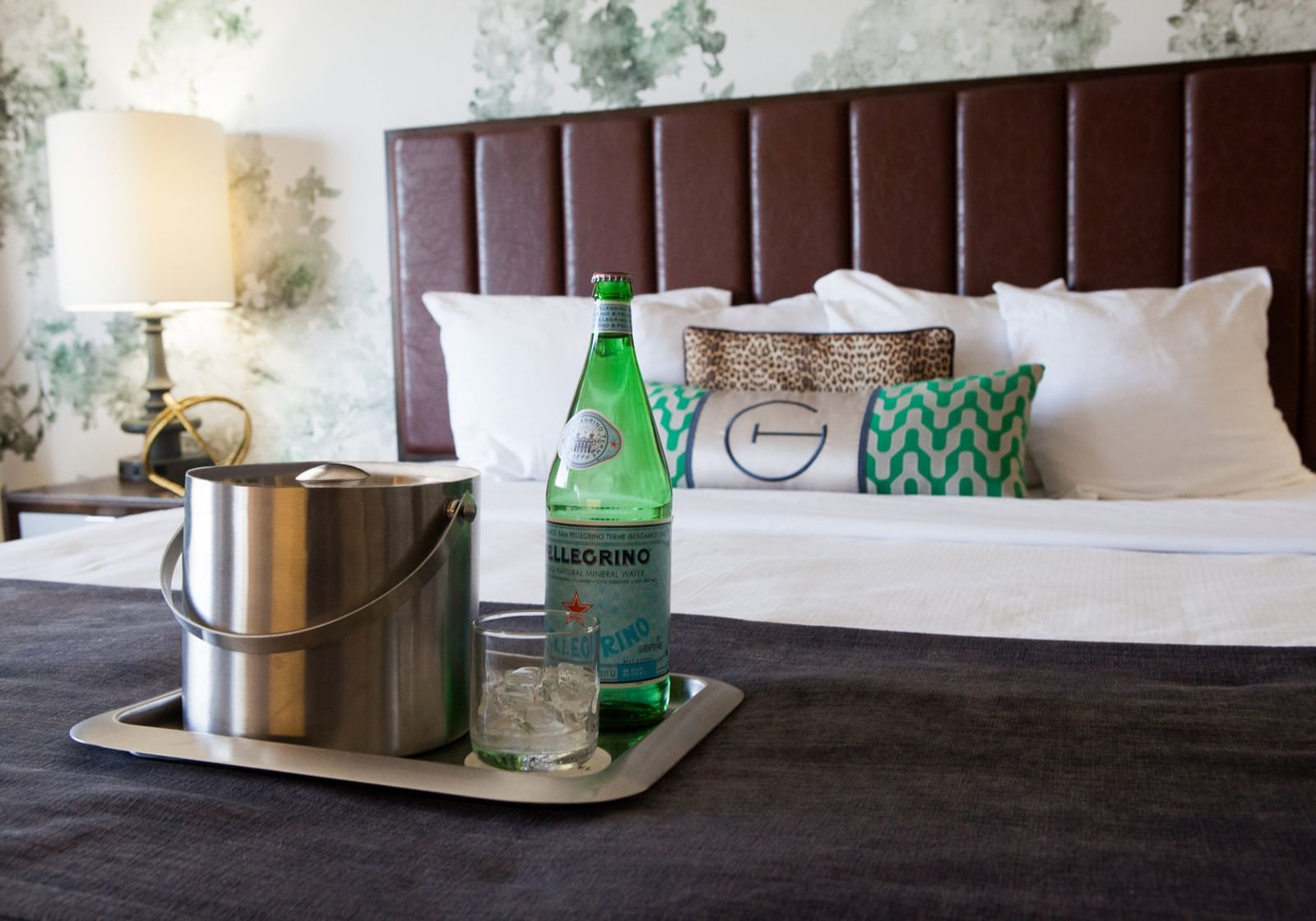 Tray with ice & sparkling water on a bed at The Grove Hotel
