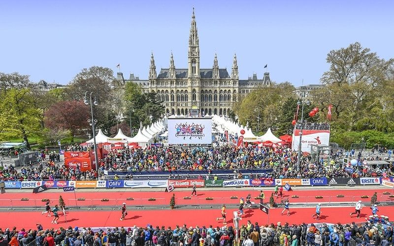 Finish area of the Vienna City Marathon in front of Vienna City Hall with cheering crowds.