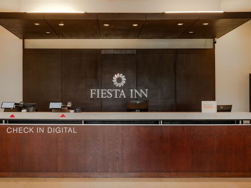 Elegant interior of reception area with hotel sign at Fiesta Inn Hotels