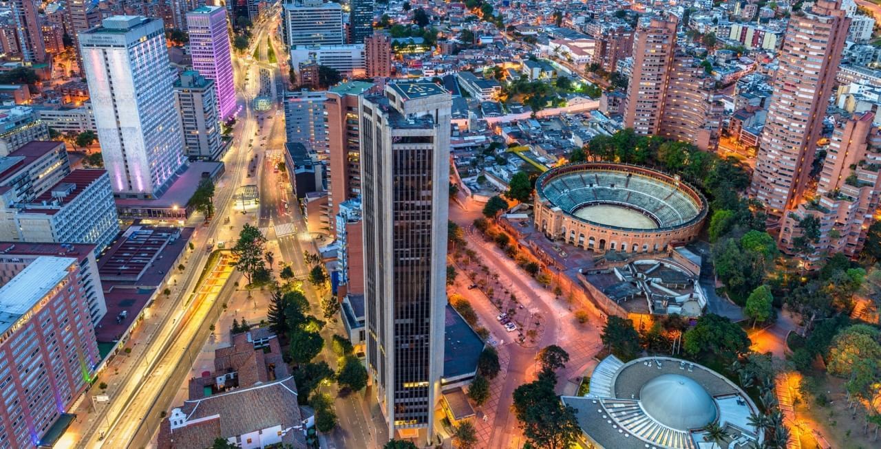 Aerial view of downtown Bogota, Colombia, showcasing city lights, tall buildings, and landmarks near Habitel Hotels