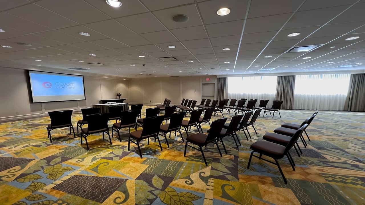 Chairs facing presentation screen in spacious room