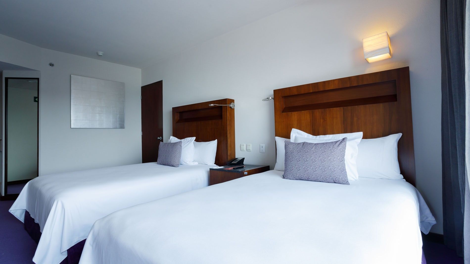 Bright 2 Double Deluxe room with two double beds and warm wood-panel headboards at Camino Real Pedregal Mexico