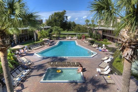 Aerial view of hotel exterior with pool by Rosen Inn International