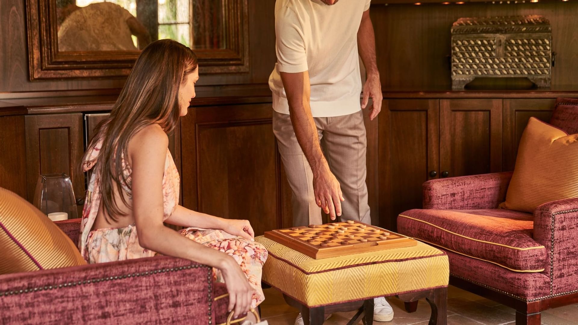 A couple playing chess in a game room at Brazilian Court