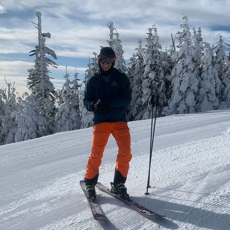 A boy with skis & ski poles on the snow near High Peaks Resort