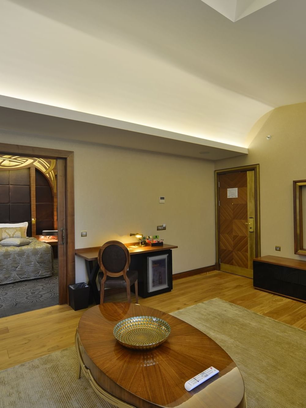 Warwick Suite with Terrace features Oval table on a rug by a TV under a soft glow at Warwick Ankara