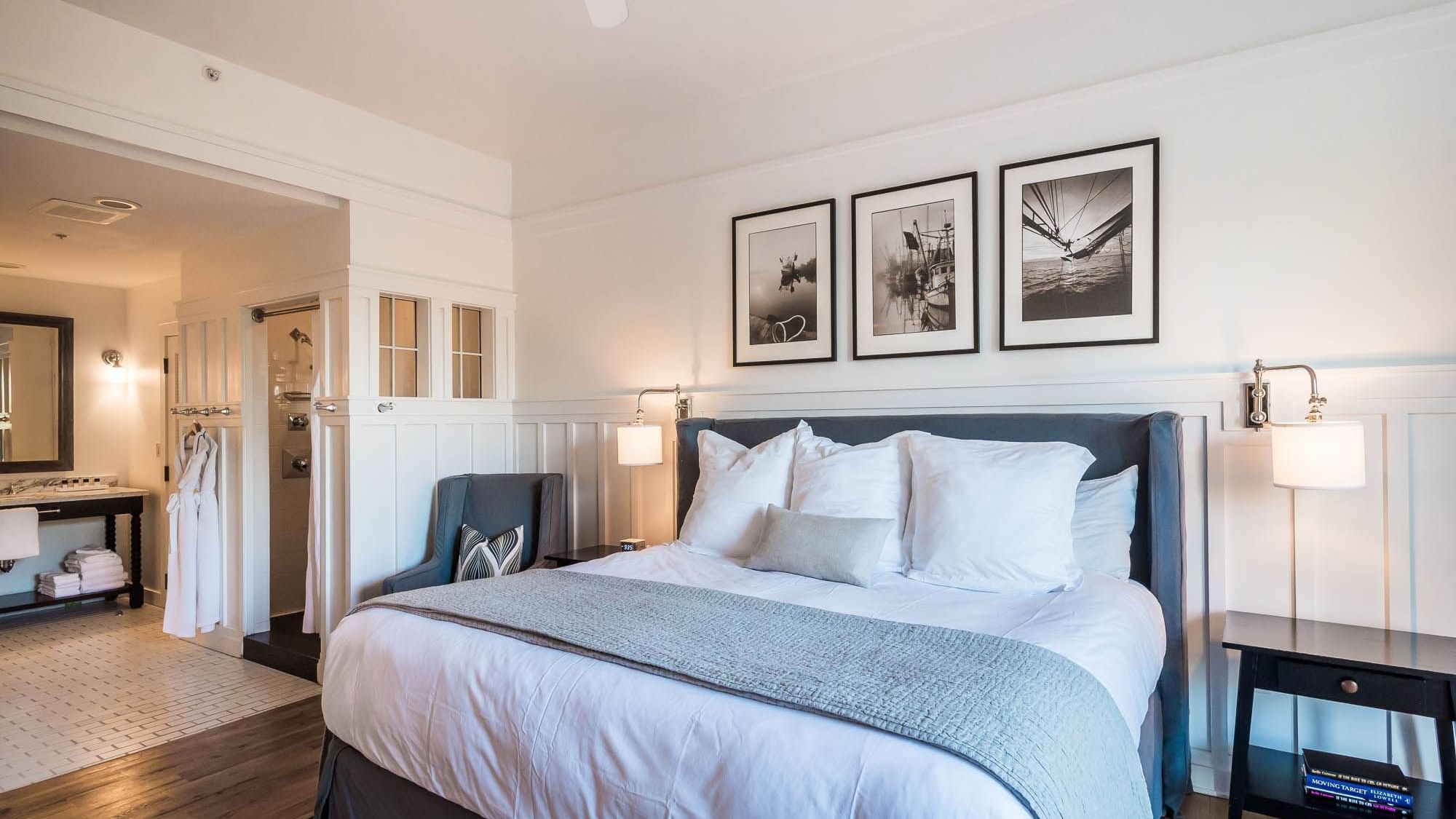 Resort suite with a comfy king bed & hanging wall paintings at Watersound Inn