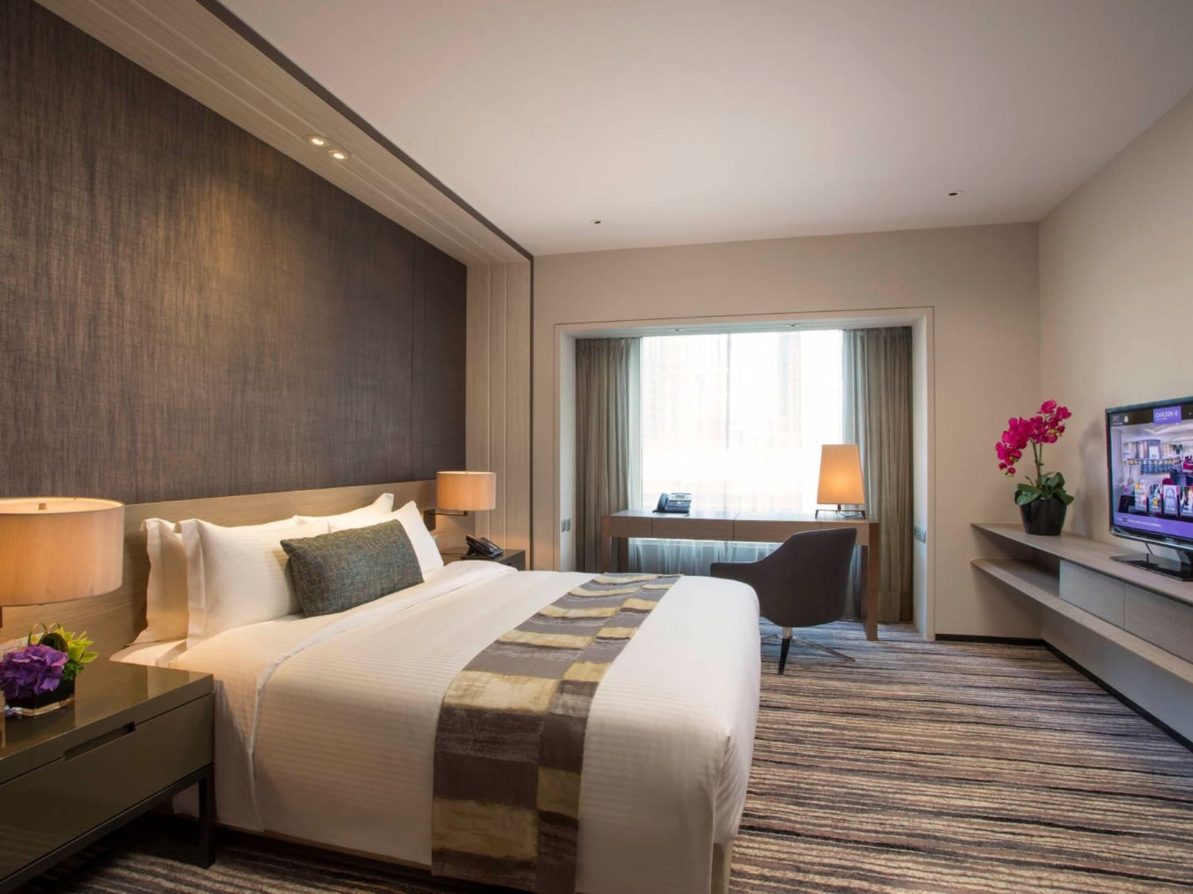 Work desk & TV by the king bed in Executive Suite at Carlton Hotel Singapore