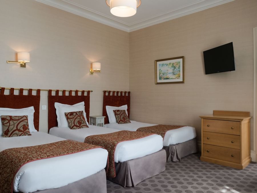 Interior of Triple Room with 3 single beds at Hotel Normandie