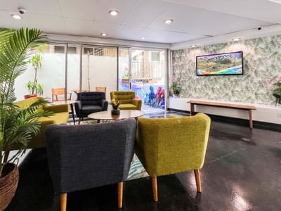 Lobby lounge area with a TV at Stay Hotel Waikiki