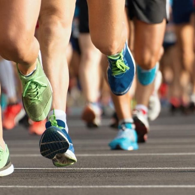 Runners' feet leading a large group in the Reading Half Marathon race.