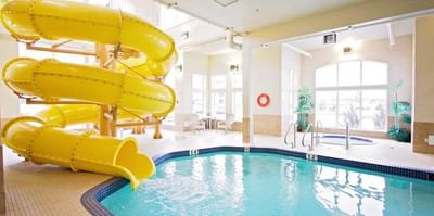 Waterslide by the pool deck in Waterpark at Service Plus Inns & Suites Drayton Valley