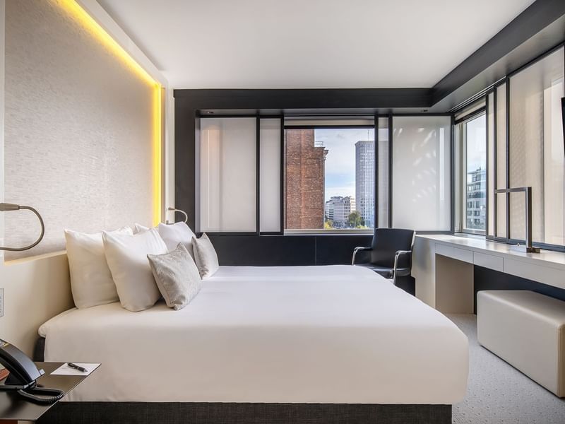 Accessible Room with a large bed, bright windows, and ambient lighting at The Hotel Brussels