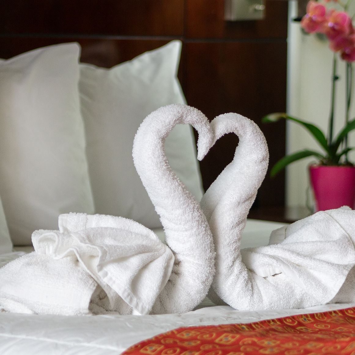 Towels rolled into a swan in a room at Flamingo Express Hotel