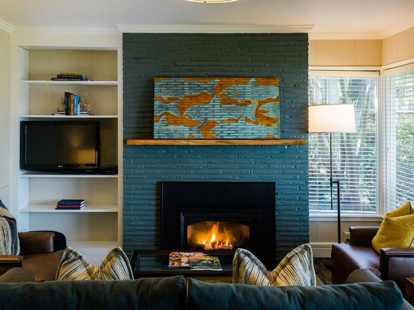 Fireplace by the rustic lounge area in One Bedroom Cottage at Alderbrook Resort & Spa