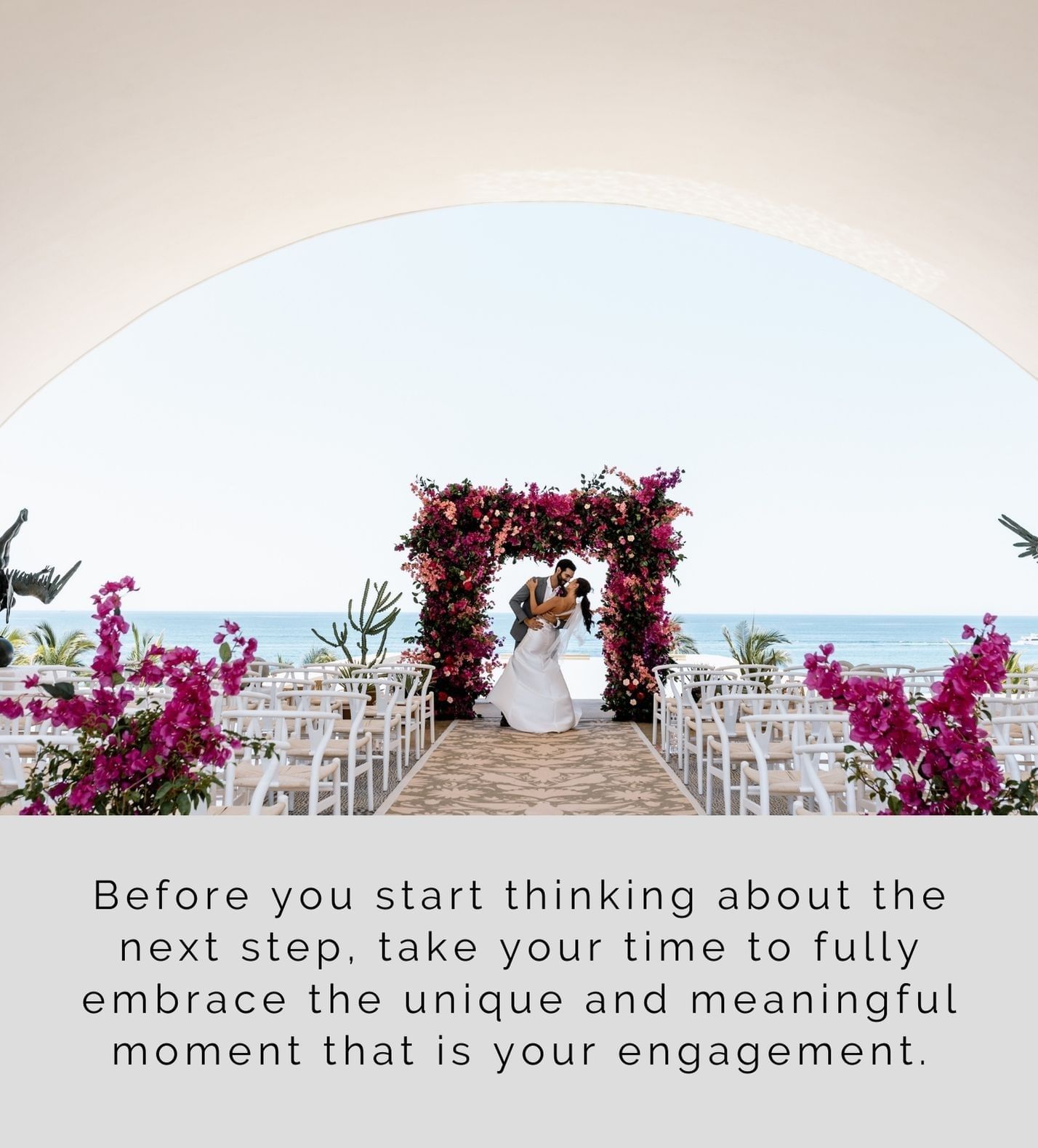 Wedded couple kissing in front of a floral arch at Marquis Los Cabos
