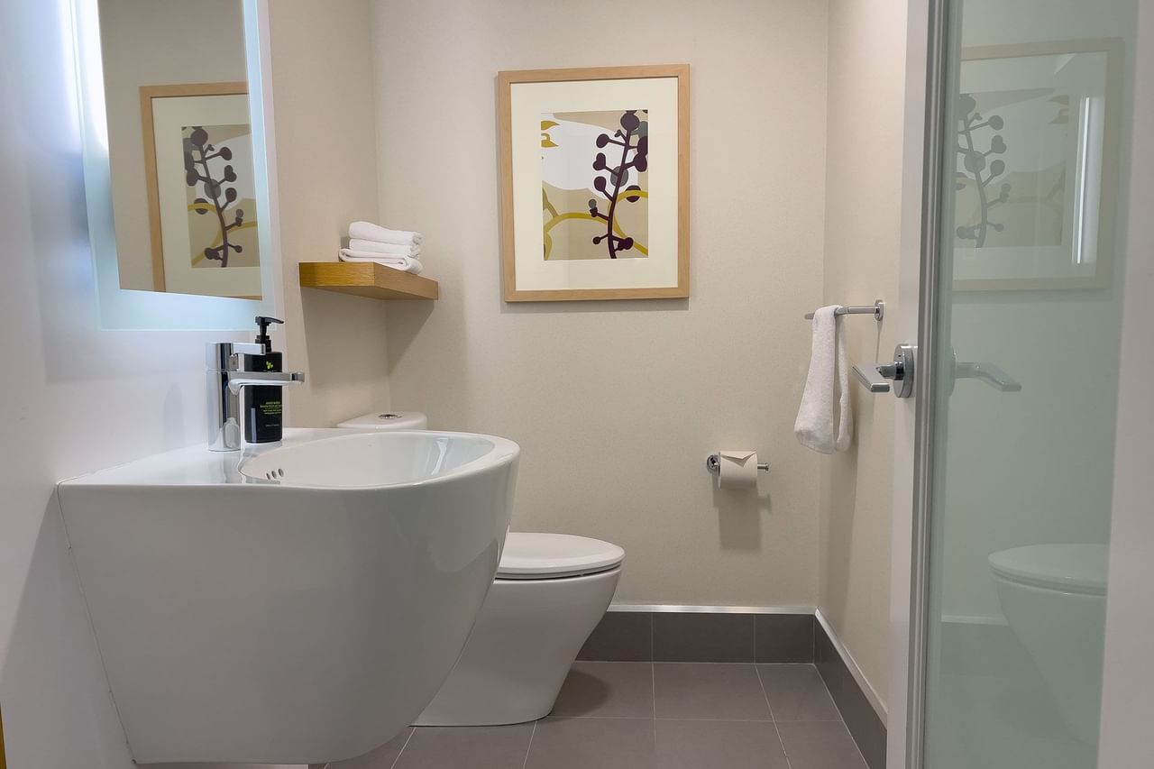 Hotel guestroom bathroom with shower