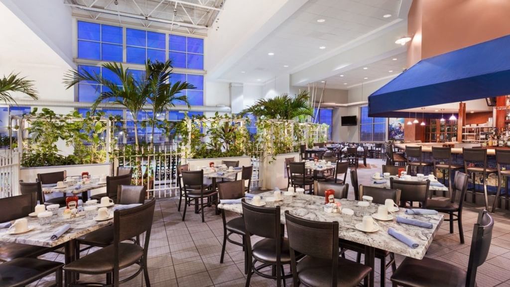 Tables set up for dining in a restaurant at Holiday Inn Hotel