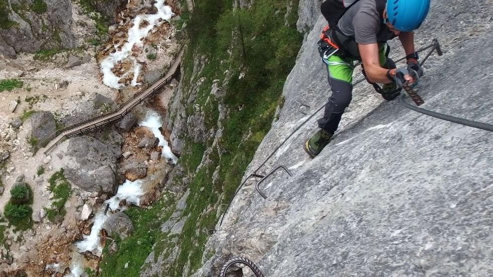 Aerial view of person climbing a rock near Falkensteiner Hotels