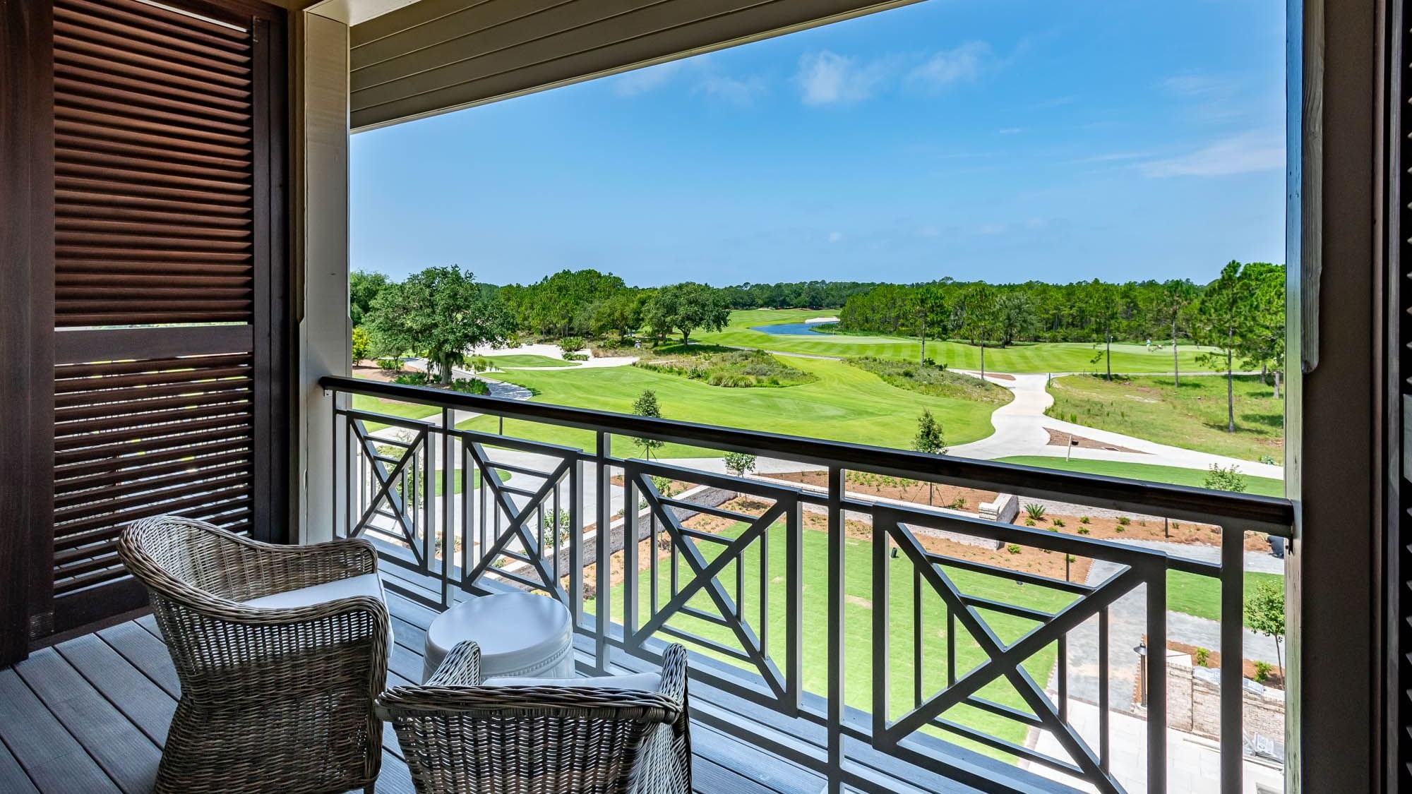 Balcony lounge area overlooking the golf ground in Golf View King Room With Balcony at Camp Creek Inn
