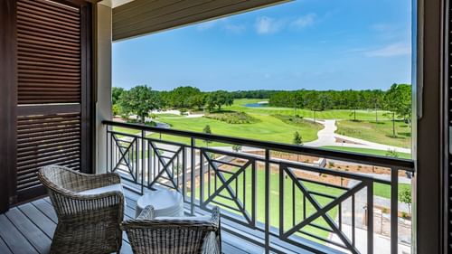 Balcony lounge area overlooking the golf ground in Golf View King Room With Balcony at Camp Creek Inn