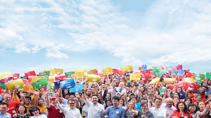 Staff posing with boards showing Sunway Lagoon's sustainability