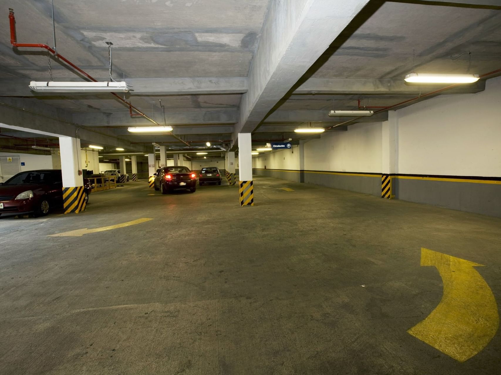 Vehicles in an indoor parking area at One Hotels