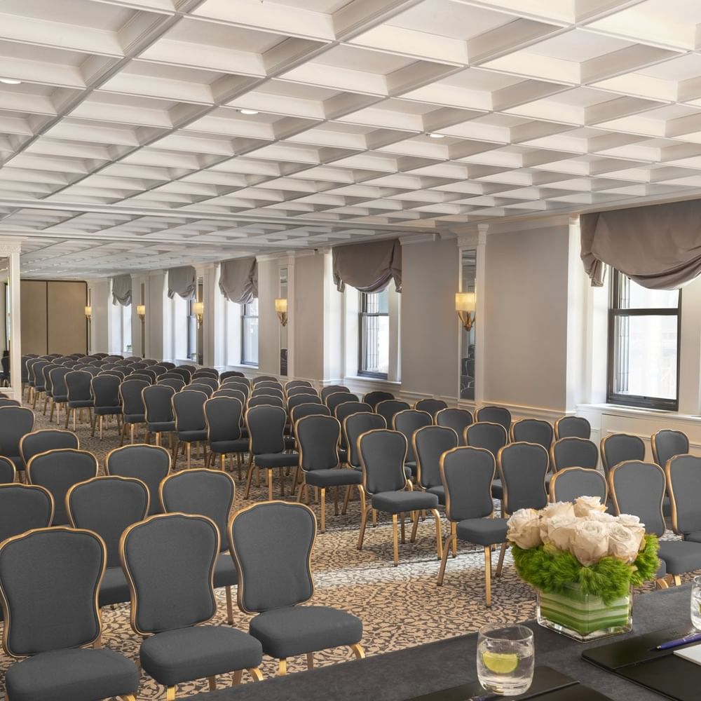 Theater style Kent Surrey Oxford with numerous rows of chairs facing desk on floral centerpiece at Warwick New York
