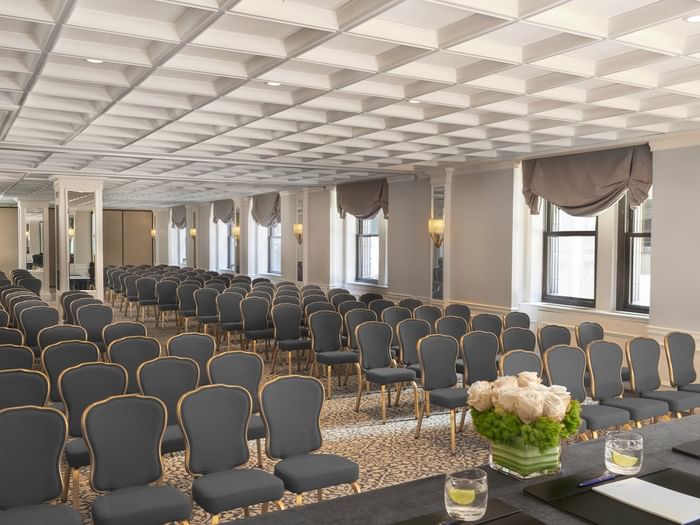 Theater style Kent Surrey Oxford with numerous rows of chairs facing desk on floral centerpiece at Warwick New York