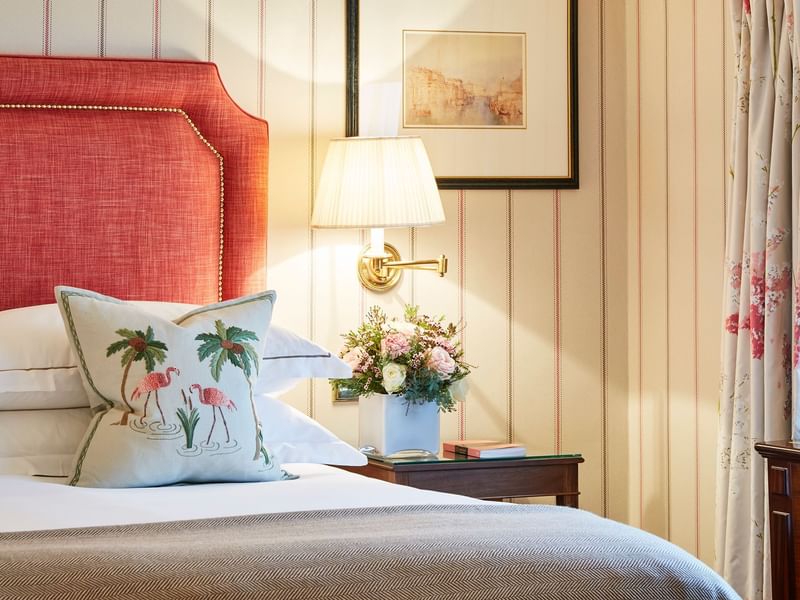 A classic lamp on a side table in a bedroom at Capital Hotel