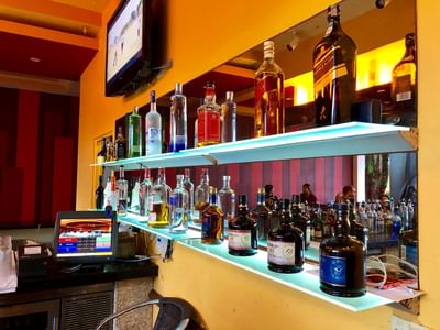 Bar area with bottles & glasses at Pegasus Hotel Guyana