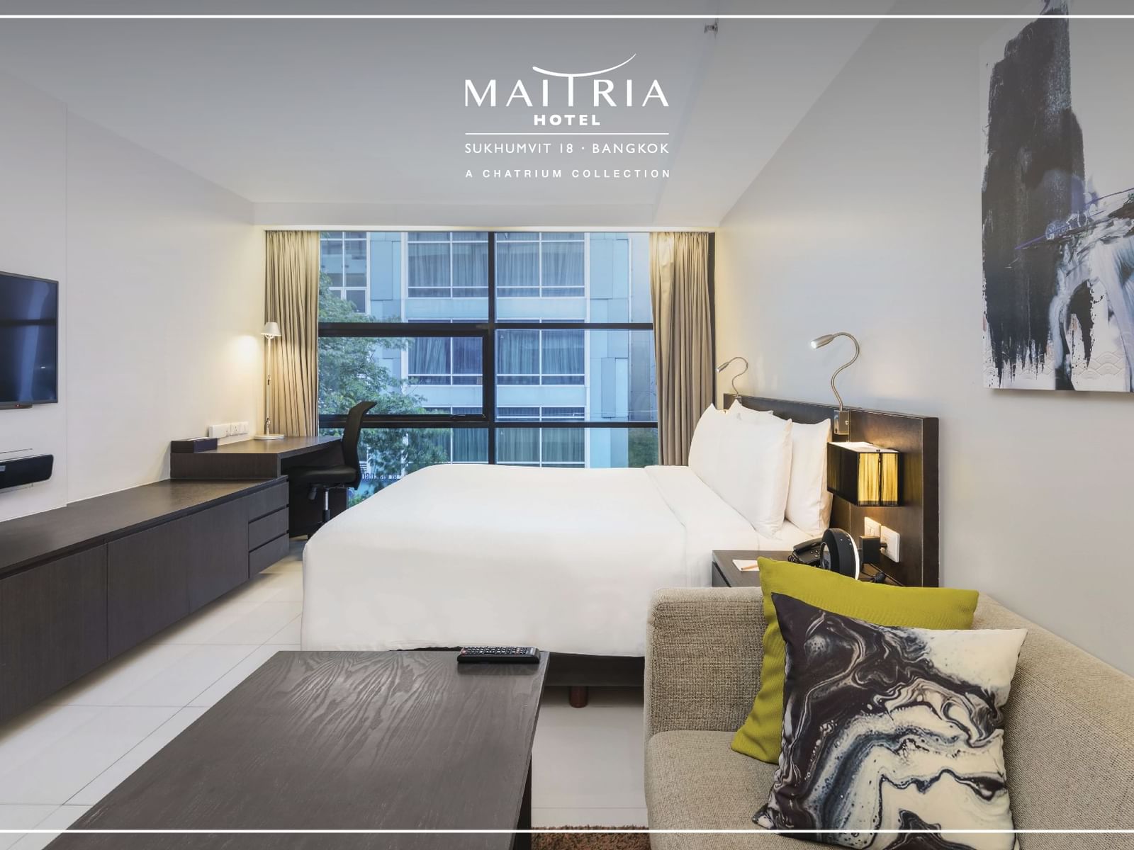 Large bed & sofa in a room at Maitria Hotel Sukhumvit 18